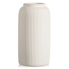 a white vase sitting on top of a table