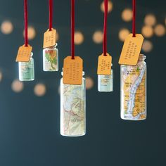 four small bottles with tags hanging from them