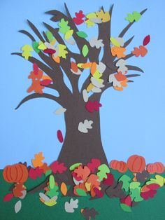 a paper cut out of a tree with leaves and pumpkins