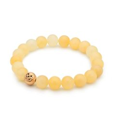 A 24ct gold plated brass pearl with a rustic surface is hidden among the pastel yellow minerals of the Honey Calcite Bracelet, giving it a special overall effect. In addition to the pleasant harmony of colors, honey calcite offers benefits such as energizing and boosting self-confidence.  The bracelet consists of 22 pearls, and thanks to its flexible design, it fits perfectly on an average female wrist.  The bracelet is handmade in our Budapest studio. MATERIAL: 24 carat gold-plated brass, honey Elegant Hand-strung Amber Bracelets, Elegant Hand-strung Amber Bracelet, Gold Bracelets With Natural Round Beads, Gold Bracelets With Round Natural Stones, Gold Agate Bracelet With Gemstone Beads, Gold Citrine Gemstone Bracelets, Adjustable Gold Citrine Bracelet, Gold Gemstone Bracelets For Healing, Gold Gemstone Bracelet For Healing