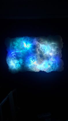 an image of clouds in the dark with blue and white colors on it's surface