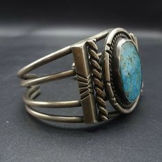 "VINTAGE NAVAJO BRACELET DESCRIPTION: This cuff features a stunning specimen of natural high blue #8 turquoise. The gemstone is secure in smooth bezel, on a foundation of heavy gauge vintage sterling silver. Twisted silver wire, chisel stamped prisms, and pulled wire cuff are additional features of this wonderful work of wearable art. This bracelet will be a cherished addition to your collection of fine vintage Native American jewelry. MEASUREMENTS: Interior of the cuff measures 5 1/8\" with an Classic Adjustable Turquoise Cuff Bracelet, Jewelry Measurements, Bones Bracelet, Vintage Native American Jewelry, Wire Cuff, Navajo Bracelet, Turquoise Bracelet Cuff, Natural High, Turquoise Cuff