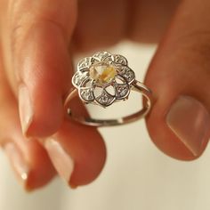 Sometimes when a girl says she likes to receive flowers as a gift, it's not the real flowers she means. Think twice and go for the safest thing - our Flora ring with Golden Rutile Ring with Moissanite. Floral jewelry is where it's at! Perfect as a graduation gift, birthday gift, anniversary ring, or a promise ring. Det Promise Flower Ring With Rose Cut Diamonds, Promise Rose Cut Diamond Flower Ring, Rose Cut Diamond Flower Promise Ring, Anniversary Jewelry With Rose Cut Diamonds In Flower Shape, Diamond Flower Ring With Birthstone For Anniversary, Flower Shaped Rose Cut Diamond Jewelry For Anniversary, Flower-shaped Rose Cut Diamond Jewelry For Anniversary, Silver Flower Jewelry For Proposal, Flower Ring With Rose Cut Diamonds For Gifts