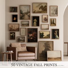 a living room filled with lots of framed pictures on the wall above a chair and table