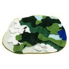 a green and white rug with blue flowers on it, sitting in front of a white background