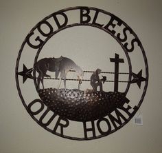 a metal sign that says, god bless our home with an elephant and two people