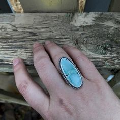 "With A Head Full Of Snow" Soft cornflower blue with a gorgeous pattern, this Gobi Desert Lavender Turquoise cabochon is set in fine and sterling silver, with a cutout sterling border. Oxidized and tumbled for a satin finish. Sterling silver split shank band. The stone setting measures approximately 34mm tall by 16mm wide. Size 6.5 US Turquoise Larimar Cabochon Jewelry, Unique Turquoise Larimar Ring, Unique Turquoise Larimar Gemstone Ring, Blue Larimar Cabochon Rings, Turquoise Larimar Round Ring, Turquoise Larimar Ring, Turquoise Larimar Ring In Silver, Turquoise Larimar Ring As Gift, Turquoise Larimar Ring For Gift