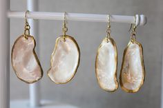 three pieces of jewelry hanging on a clothes line