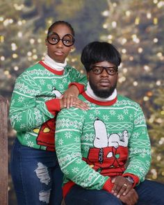 two people wearing ugly christmas sweaters sitting on a bench