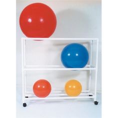 three different colored balls sitting on top of a white rack