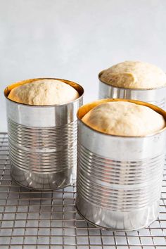 three tin can cakes sitting on top of a cooling rack next to eachother