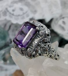 Natural Purple Amethyst Ring Intricate Design#149 Custom Made Inspired by Victorian era designs, I now offer this lovely filigree reproduction in sterling silver. This is a flawless natural purple amethyst is 12mm by 10mm in Length & Width. The ring is 3/4th of an inch North/South on the finger. The inside of the band is etched 925. Notice the intricate and detailed Victorian design of the antique patina silver filigree setting all the way down the band. This is an exquisite rendition of an Purple Amethyst Ring With Intricate Design, Purple Amethyst Ring With Intricate Design For Promise, Purple Amethyst Promise Ring With Intricate Design, Purple Promise Ring With Intricate Design, Purple Intricate Design Promise Ring, Purple Anniversary Rings With Intricate Design, Heirloom Amethyst Rings With Intricate Design, Antique Purple Amethyst Ring With Accent Stones, Fine Jewelry Amethyst Ring With Intricate Design For Anniversary