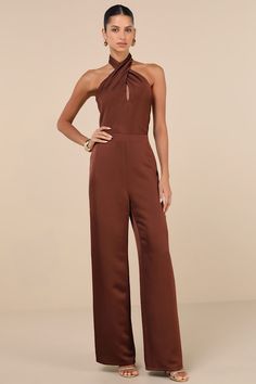 The Lulus Beyond Classy Brown Satin Halter Wide-Leg Jumpsuit is perfect for a night of bubbly and dancing! Sleek woven satin shapes this sensational jumpsuit that has a halter neckline (with button closures) and a sleeveless, cross-front bodice with a flirty keyhole cutout at the front and a sexy backless design. The fitted waist tops trendy, wide pant legs that fall to ankle-length hems. Hidden back zipper/clasp. Fit: This garment fits true to size. Length: Floor length. Size medium measures 66.5" from top to bottom. Inseam: 32.00 Front Rise: 13.75 Bust: Great for any cup size. Waist: Fitted - very fitted at natural waist. Hip: Loosely Fitted. Undergarments: May be worn with an adhesive bra, petals, or no bra. Fabric: Fabric has no stretch. Lined. Shell: 100% Polyester. Lining: 100% Polye Fitted Brown Jumpsuits And Rompers For Party, Brown Jumpsuit, Brown Jumpsuits, Halter Neck Jumpsuit, Tops Trendy, Silk Romper, Brown Satin, Fashion Figures, Adhesive Bra