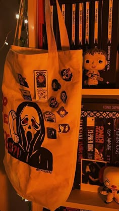 a bag with stickers on it sitting next to a book shelf filled with books