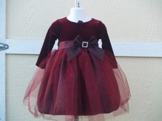 "This is a beautiful, New, Upcycled dress. New dress with Tags! Pictures do not do any justice to this gorgeous dress. This dress comes in a beautiful shade of Burgundy, also available in True Red. The top is Velvet and has a very pretty handmade fabric flower on the round neckline, has long sleeves, and a beautiful taffeta bow with a rhinestone buckle. The top of the skirt is a gorgeous glitter tulle with some hints of red. Dress has a built in crinoline. Please see all pictures!! FOR RED: www. Elegant Tulle Dresses For Holiday, Elegant Tulle Princess Dress For Holiday, Elegant Holiday Princess Dress In Tulle, Holiday Tulle Fitted Dress, Fitted Tulle Dress For Holidays, Holiday Princess Dress In Tulle, Elegant Christmas Tutu Dress For Holiday, Elegant Christmas Holiday Tutu Dress, Holiday Tulle Princess Dress