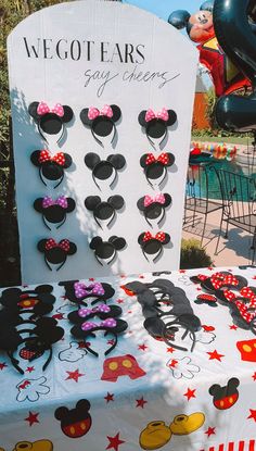 a table topped with lots of mickey mouse ears