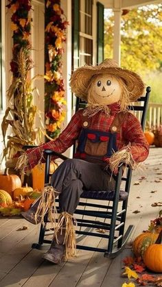 a scarecrow sitting in a rocking chair on the porch