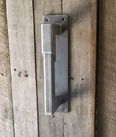 a metal door handle on a wooden door