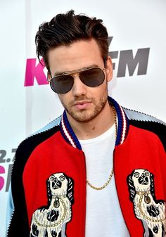 a man wearing sunglasses and a red jacket