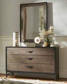 a dresser with two drawers and a mirror on it's sideboard in a living room