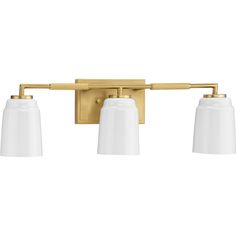 three light bathroom fixture with white glass shades on the sides and gold finish, in an aged brass finish