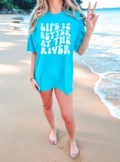 "⚓Get ready to make a splash with our \"Life Is Better At the River\" shirt for girls! Designed for bachelorette trips and river adventures, this retro-style tee is perfect for floating, kayaking, and paddleboarding. Make waves and show off your river babe vibes with this fun vacation shirt. So what are you waiting for? Click ADD TO CART now! 👕 PRODUCT INFO The Comfort Colors 1717 shirt is made of 100% ring-spun cotton, pre-shrunk, and double-needle stitched for added durability. It offers a relaxed fit and a wide range of colors, and the pigment-dyed fabric gives the shirt a vintage, lived-in look. This shirt is budget-friendly, versatile and comfortable, making it a perfect choice for anyone looking for a durable t-shirt. ✏️ DESIGN Designs are printed onto the shirt using Direct to Garm Kayak Gifts, River Shirts, Travel Tees, Bachelorette Trip, Bachelorette Shirts, Vacation Shirts, Matching Shirts, Style Retro, Family Shirts