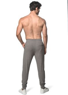 Ultimate comfort meets effortless style in our classic stretch rib knit joggers with a sleek modern fit. Features deep slide front pockets, faux fly detail, interior draw cord, zipped back pocket, dyed to match rib-knit ankle cuffs and relaxed elastic continuous waistband that gently hugs the waist, ensuring a comfortable fit throughout the day. Fabricated from an irresistibly soft, cashmere-like hand feel, viscose/ rayon blend rib knit fabric with a sueded finish, providing butter-like softness Knit Joggers, Rib Knit Fabric, Swim Pants, Viscose Rayon, Fleece Shorts, Ankle Cuffs, Short Shirts, Knit Shorts, Modern Fit