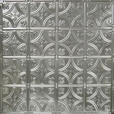 a close up view of a metal door with decorative designs on the front and sides