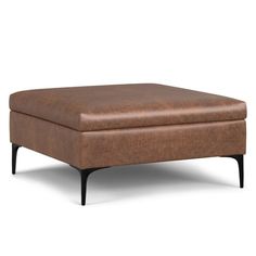 a brown ottoman sitting on top of a white floor