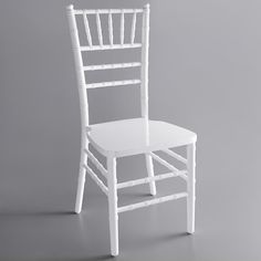 a white wooden chair on a gray background