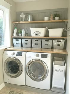 a washer and dryer in a laundry room with shelves above them that hold baskets