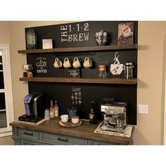 the coffee bar is decorated with chalkboard and wooden shelves above it, along with other items