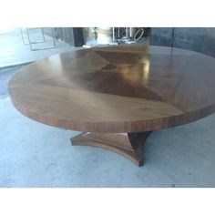 a round wooden table with an interesting design