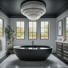 a large bathtub sitting in the middle of a bathroom next to two windows and a sink