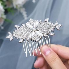 a close up of a person holding a hair comb