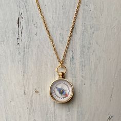 Small working magnetic compass on 18" of gold plated chain. Vintage Gold Necklace With Compass Design, Gold Vintage Necklace With Compass Design, Brass Compass Design Round Pendant Necklace, Brass Jewelry With Compass Design Round Pendant, Gold Brass Jewelry With Compass Design, Travel-themed Compass Design Round Pendant Necklace, Gold Medallion Jewelry With Compass Design, Gold Compass Design Necklace For Travel, Gold Round Pendant Necklace For Travel