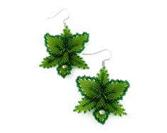 Step into a lush tropical paradise with these stunning Green Orchid Floral Earrings, meticulously crafted by a skilled artisan. Each earring features delicate beadwork that captures the intricate beauty of a blooming orchid, making them a truly enchanting addition to any jewelry collection. Indulge in the vibrant hues of green, reminiscent of lush tropical forests, adding a touch of exotic elegance to your ensemble. These botanical-inspired earrings are perfect for celebrating the beauty of natu Botanical Green Jewelry With Ear Wire, Botanical Green Drop Earrings, Green Botanical Drop Earrings, Green Flower Beaded Earrings Gift, Green Flower Earrings With Round Beads, Green Botanical Drop Earrings Jewelry, Green Flower Beaded Earrings For Gift, Botanical Style Green Flower Jewelry, Blooming Orchid