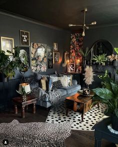 a living room filled with furniture and lots of plants