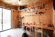 a room with wooden walls and shelves filled with bikes