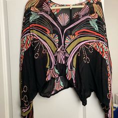 Never Worn, Free People Blouse. Cinched Waist And Sleeves. Beautiful Colors, Sheer. Black Long Sleeve Top With Abstract Print, Black Long Sleeve Tops With Abstract Print, Black V-neck Blouse For Beach, Black Printed Tops For Festival, Black Bohemian Printed Blouse, Chic Beach Tops With Abstract Print, One Size Long Sleeve Tops With Floral Print, Bohemian V-neck Blouse With Graphic Print, Black Floral Print Vacation Blouse