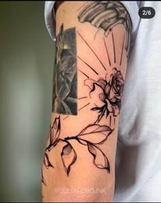 a person with a tattoo on their arm that has an image of flowers and leaves