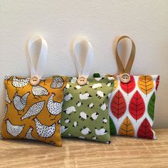 three small purses are lined up on a table