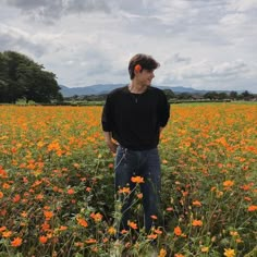 a man standing in a field of flowers