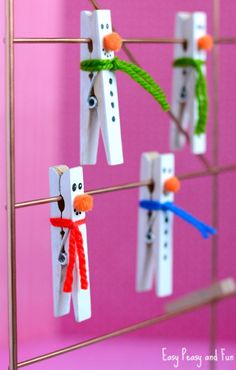 some clothes pins are attached to a pink wall