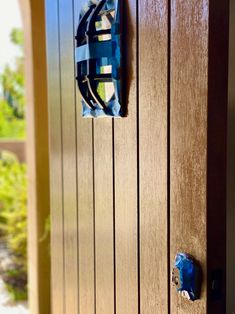 a close up of a wooden door with a metal handle on the front and side