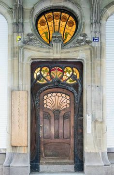 an ornate door with stained glass above it