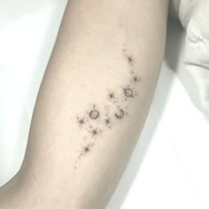 a woman's arm with stars and crescents on the back of her left arm