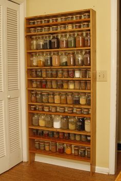 a wooden shelf filled with lots of jars