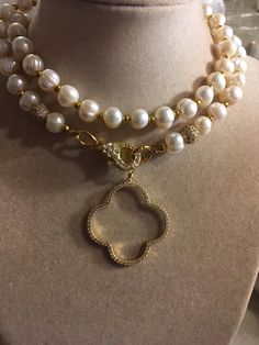 This pearl necklace is made of freshwater pearls, gold plated: beads, cz lobster claw clasp, cz quatrefoil pendant and findings. This necklace measures 34 inches in length and the pendant is 1 1/2 inches. This necklace can also be made in silver. The pictures do not do it justice. I have the necklace and so do several of my friends. We all get sooooo many compliments on it! All of our jewelry is unique and custom designed. Most of our jewelry can easily be resized. If there is a piece of jewelry Luxury Gold Pearl Beaded Necklaces, Yellow Gold Beaded Pearl Necklace For Wedding, Wedding Yellow Gold Beaded Pearl Necklace, Gold Akoya Pearl Beaded Necklace, Luxury Gold Beaded Necklaces For Wedding, Gold Pearl Beaded Necklaces For Anniversary, Gold Beaded Necklace With Pearl Chain For Anniversary, Exquisite Pearl Necklace With Pearl Charm, Gold Beaded Pearl Chain Necklace For Anniversary