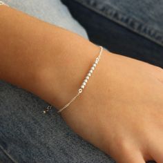 Simple and beautiful, this bar bracelet features 3 mm silver beads/balls on a bar - the perfect minimalist piece. Wear it on its own or layer with other pieces from our collection and it's adjustable!   💖 Details 925 Sterling Silver Balls: approx 3 mm Length of bar: approx 25 mm Length: approx 17 - 19 cm including 2 cm extension 💕 Stay up-to-date with new designs & special offers - FOLLOW ME - website: thejewellerytree.net   Socials: @myjewellerytree OR https://www.facebook.com/thejewellerytree1/   💕 Need more info, feel free to email - I'd love to help 💕And please visit my NEW store https://www.etsy.com/au/shop/TheJewelleryTreeCo  We care about the environment so when you buy any of our pieces, you'll receive beautiful long lasting jewellery with minimal packaging - a card made of rec Silver Bar Bracelet, Silver Bracelet For Women, Silver Bracelets For Women, Bar Bracelet, Bracelet Bead, Sterling Bracelets, Ball Bracelet, Silver Bar, Silver Chain Bracelet